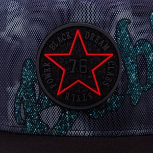 Close-up of hip hop hat with star logo patch and intricate camouflage mesh pattern