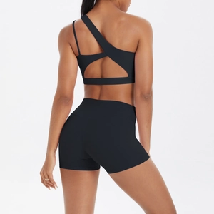 Rear view of black one-shoulder sports bra with cutout and matching high waist gym shorts