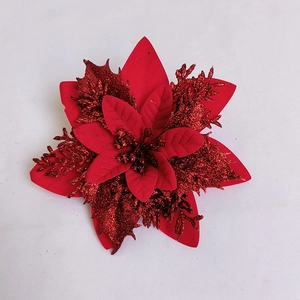 Close-up of a 14cm red artificial poinsettia flower with sparkling glitter for Christmas