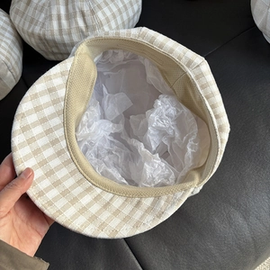 Close-up of the beige plaid linen beret interior featuring the sweatband and lining detail