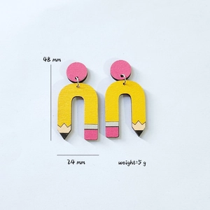 Creative yellow pencil earrings 48mm tall 5g weight on minimalist grey background