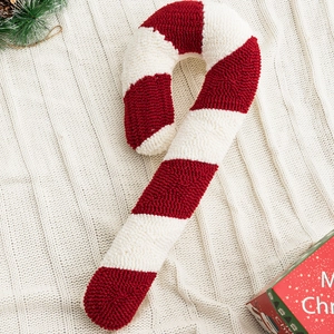 Christmas candy cane shaped pillow with red and white stripes in cozy boucle fabric