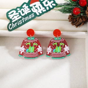 Close-up of festive red glitter acrylic earrings in a Christmas sweater shape with snowflakes