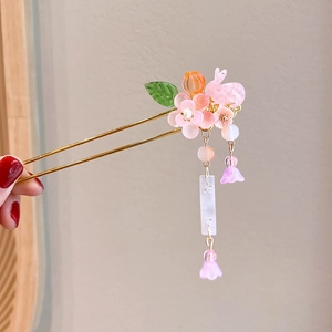 Close-up of pink rabbit hair stick with floral tassels and jade-like pendants