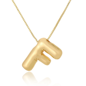 Detailed view of a gold bubble letter F pendant with a thin minimalist chain on white background