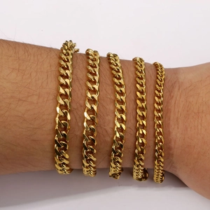 Detail shot showing five varying widths of gold-plated Cuban link chain bracelets for men and women