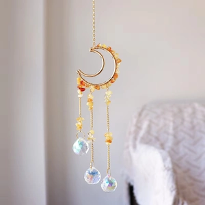 Detailed close-up of golden moon suncatcher with yellow crystals and three clear prisms