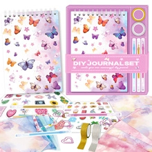 Detail view of pink butterfly DIY journal set including notebook, pens, and stickers