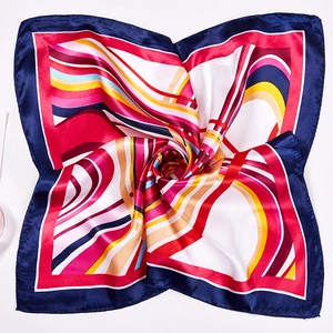 Detailed close-up of a 50cm square silk scarf with geometric chain prints and satin texture