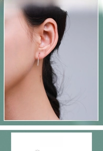 Detail of elegant s925 silver long rose gold threader earrings worn by a model