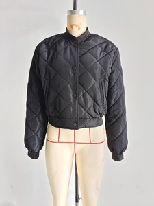 Detailed view of black quilted jacket with classic ribbed collar and snap buttons