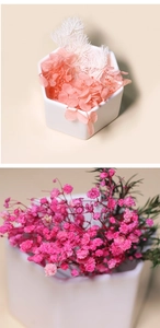 Vertical view of white ceramic hexagonal pots with pink hydrangeas and dried flowers