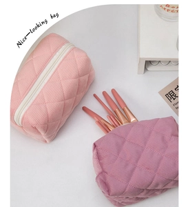Detailed view of quilted cotton cosmetic bags in pink and dusty rose with diamond stitching
