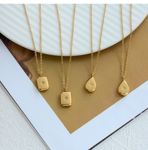Detailed macro view of 18K gold-plated starburst pendants on fine cable necklaces
