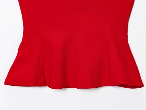 Detail shot of the ruffled hem and vertical stitching on this red A-line camisole top