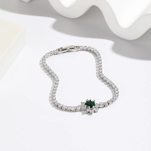 Elegant silver floral bracelet with a brilliant green zircon center and white accents