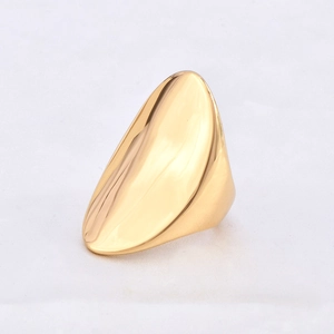 Detailed view of large teardrop-shaped 18k gold plated ring on white textile background