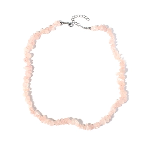 Detailed macro view of irregular natural pink crystal gravel stones on a delicate necklace