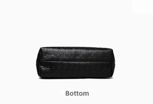 Detailed bottom view of large black tote bag featuring skull embossed lychee leather texture