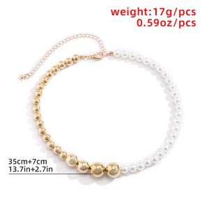 Detail showing asymmetric gold beads and pearl necklace with lobster clasp and extension