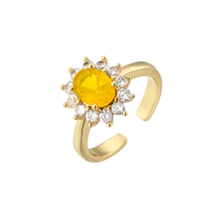 Detail of yellow oval gemstone ring with 18K gold plated sunflower halo design