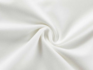 Detailed macro view of the soft white knitted fabric showing fine texture and elasticity