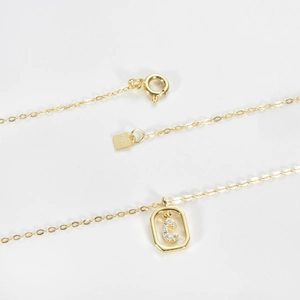 Close-up of S925 sterling silver gold-plated necklace with letter C octagon pendant