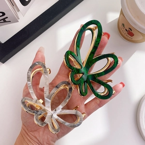Elegant acetate butterfly hair claws with marble and ink textures for stylish updos