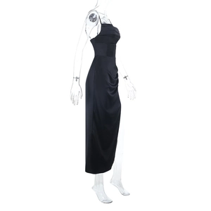Detail of black satin evening dress showing side ruching and elegant high slit design