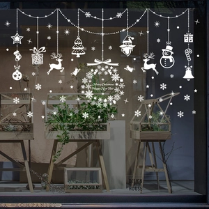White Christmas window stickers featuring reindeer, snowman and snowflakes on glass display