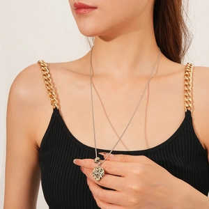 Close-up of heart-shaped resin stone pendant necklace with spots on a fashion model
