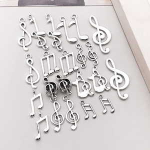 Vielfalt an silbernen Musiksymbol-Anhängern wie Notenschlüssel und Noten für DIY-Schmuck