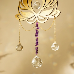 Detailed close-up of golden lotus suncatcher with amethyst stones and crystal prism ball