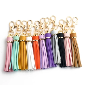 Detailed close-up of colorful faux leather tassel keychains with gold metal clasps