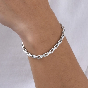 Detail of silver stainless steel chain link bracelet worn on wrist for a modern look