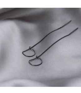 Detail of matte black minimalist geometric drop earrings with slender metal chain link