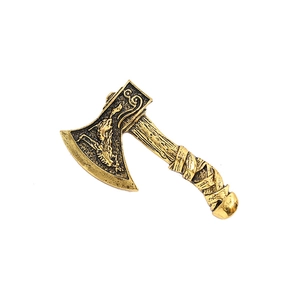 Detailed view of vintage gold axe brooch with dragon relief and textured metal finish