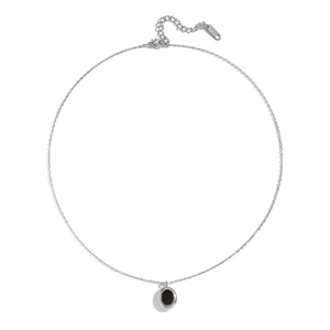 Close-up of a silver stainless steel chain necklace with a black oval pendant on white backdrop