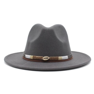 Detail of grey wool fedora hat with a woven ethnic band and golden shell accessory