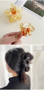 Macro detail of resin flower claw clips with glitter finish and hair styling view
