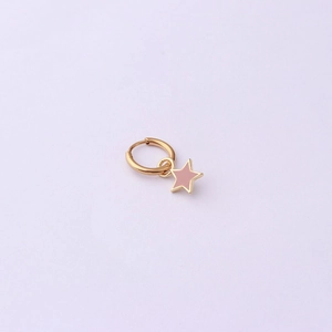 Macro detail of golden huggie hoop earring featuring a pink enamel star charm pendant