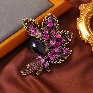 Vintage floral crystal brooch with purple rhinestones on antique gold alloy base