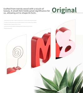 Detail view of red wooden heart stand with a metal spiral wire clip for photos and cards