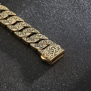Macro detail of vintage gold-plated titanium steel bracelet with baroque floral engravings