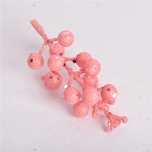 Close-up of pink glitter artificial berry stems for Christmas tree and DIY decoration