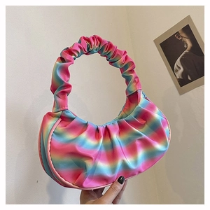 Detail of a pleated rainbow gradient dumpling bag with a scrunchie-style shoulder handle