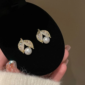 Elegant gold plated leaf pearl earrings with cubic zirconia set in a black jewelry box