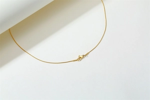 Detail of 18K gold plated stainless steel snake chain with a secure spring clasp closure