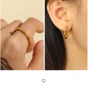 Detailed view of gold bamboo style ring and earrings set with high polish finish