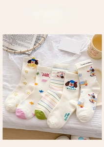 Detailed view of five pairs of cotton mid-calf socks with cute cartoon puppy patterns